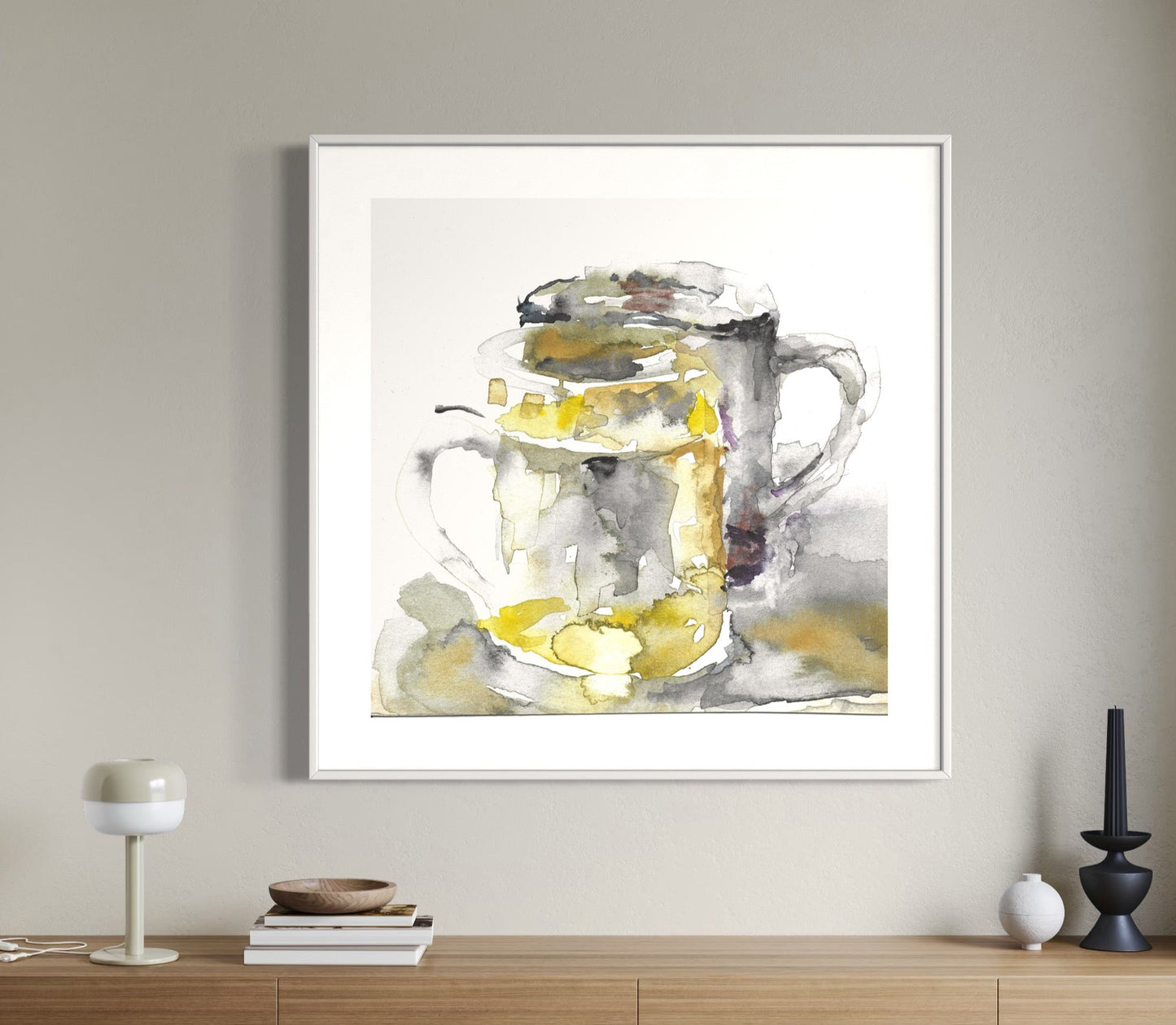 A framed watercolor painting of a beer mug hanging on a wall above a wooden console table.