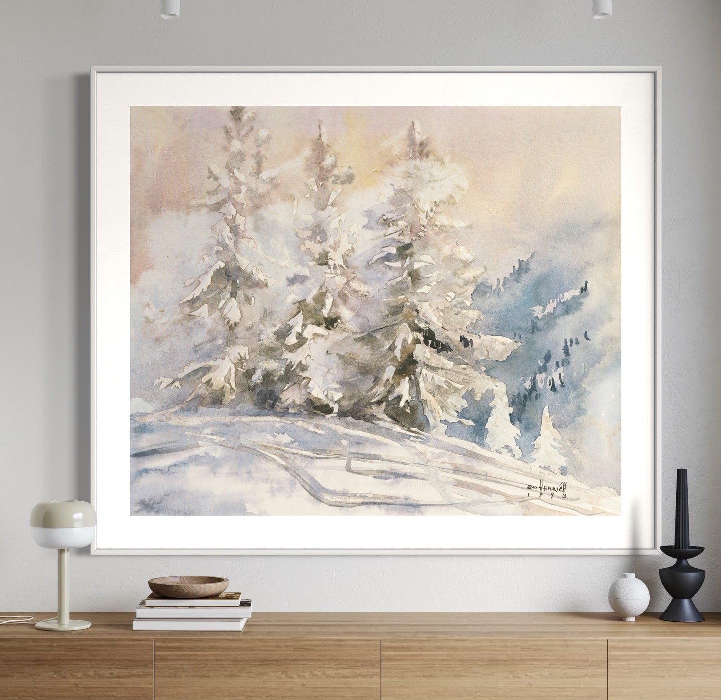 Framed winter landscape painting on a wall.