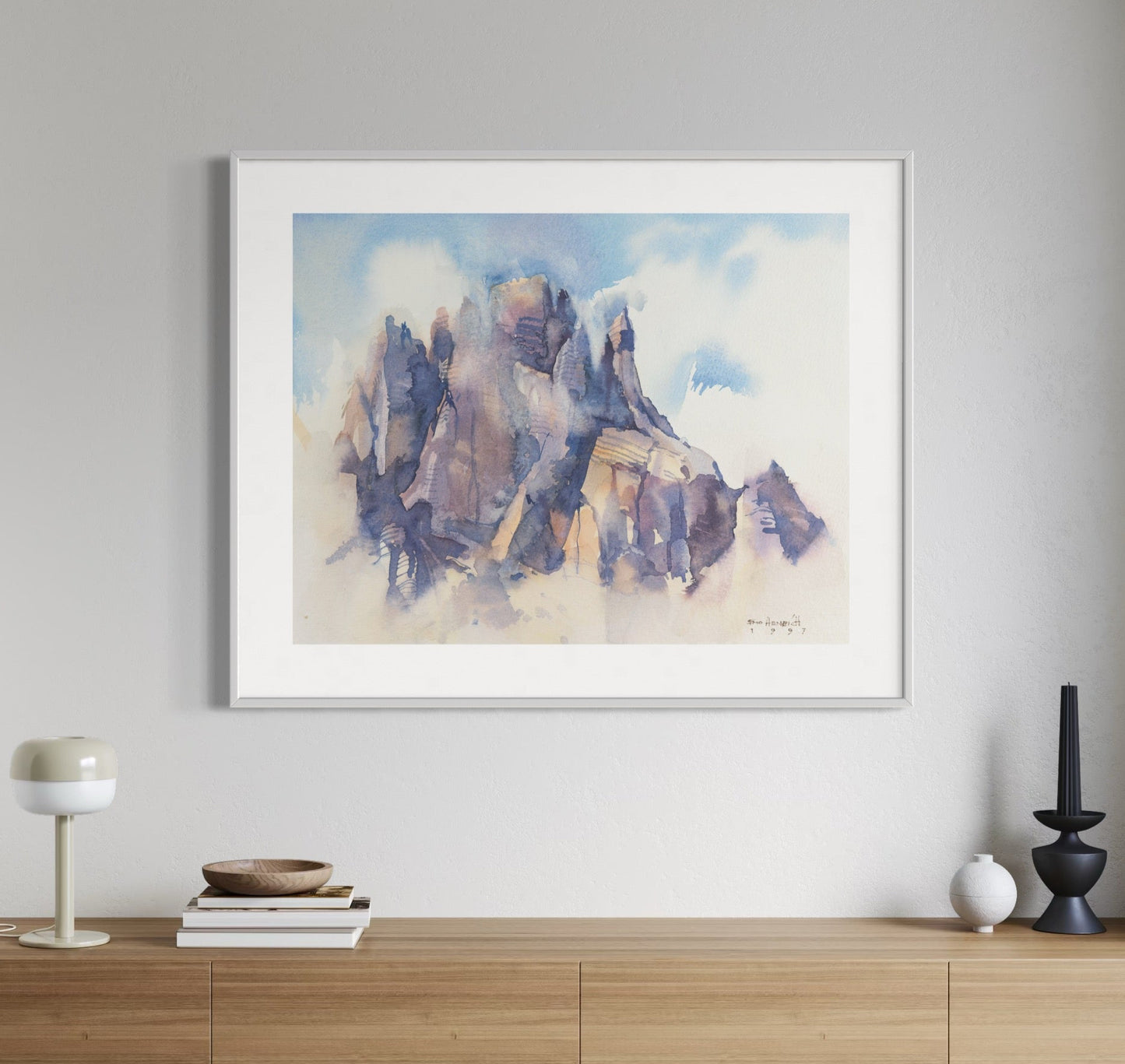 Framed painting of a mountains on a wall