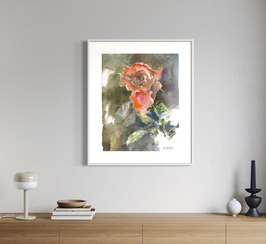 Framed floral artwork on a wall above a wooden cabinet.