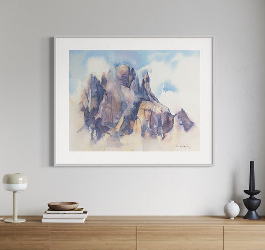 Framed painting of a mountains on a wall