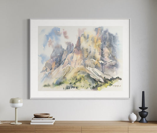 Framed abstract mountain painting above a wooden console table in a modern interior.