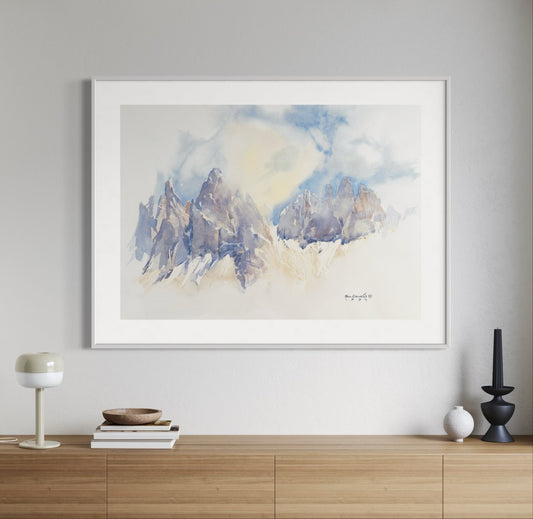 Framed abstract art piece on a wall above a wooden console table.